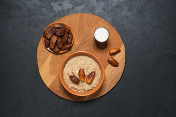 Healthy eating, healthy breakfast food. Oatmeal porridge with dates and milk.
