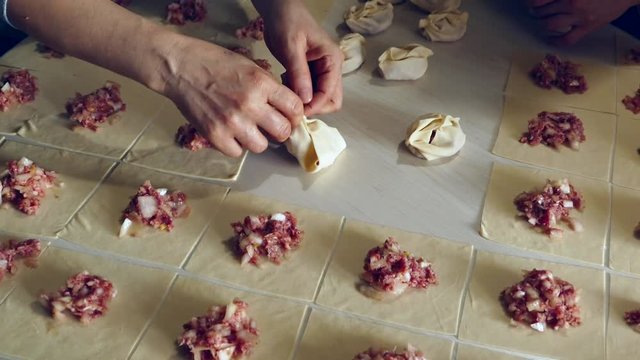 Kyrgyz ravioli, a woman doing ravioli, meat ravioli, pasty woman who.make ravioli with dough.