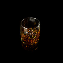Isolated shot of whiskey with splash on black background