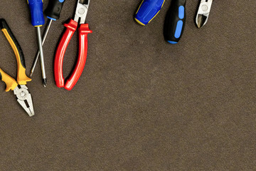 construction background set of tools blue screwdriver cutting pliers on a dark background design background copy space