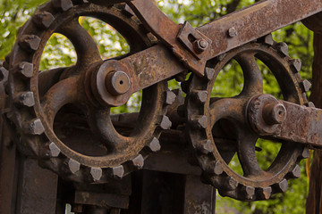 big gear old mechanism engine group of shafts background industrial grunge street sawmill texture metal rusty close-up