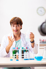 Fototapeta premium Chemist blogger recording video for his blog
