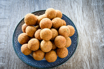 Deep fried fish balls on a bowl on wooden background