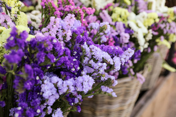 Variety of limonium sinuatum or statice salem flowers in blue, lilac, violet, pink, white, yellow colors in the garden shop.