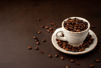 Coffee cup and beans on a concrete table
