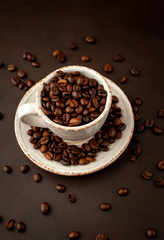 Coffee cup and beans on a concrete table
