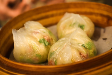 Three dim sum steam dumplings in the basket in Hong Kong