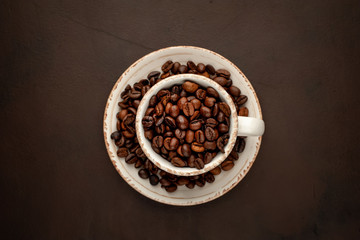 Coffee cup and beans on a concrete table
