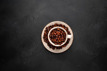 Obraz na płótnie Canvas Coffee cup and beans on a concrete table