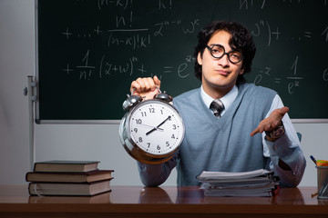 Young math teacher in front of chalkboard