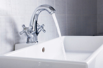 New plumbing. Chrome faucet and white sink in the bathroom.