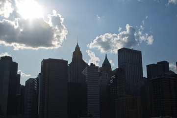 Fototapeta premium A cluster of buildings on New York City's lower Manhattan as seen from the Brooklyn Bridge.