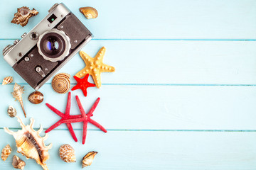 Fototapeta na wymiar Sea stars and shells on wooden background.Top view travel or vacation concept. Summer background
