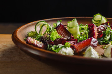 Salad with tuna, cheese and greens. Backlight.