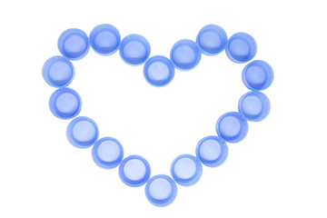 Heart made of blue plastic botlle сaps isolated on white background
