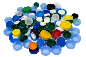 Pile of many colored plastic caps isolated on white background