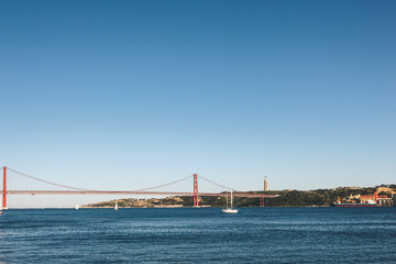 The Christ the King statue and 25 April bridge over the Tagus river in Lisbon, Portugal