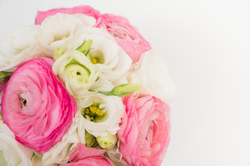 Ranunculus and lisiathus floral bouquet flat lay on white background
