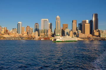 Seattle skyline with a ferry and blue sky taken from the water