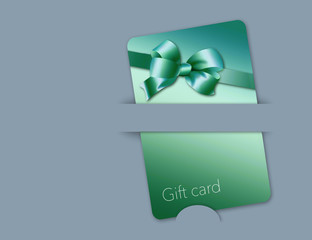 Here is a retail gift card that is gold colored with a golden bow design. It is on a blue background.