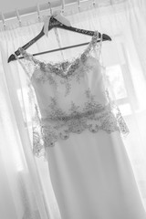 White wedding dress hanging up before the wedding