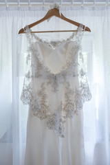 White wedding dress hanging up before the wedding