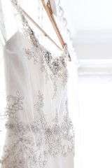 White wedding dress hanging up before the wedding