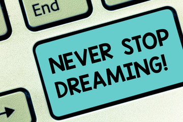 Fototapeta premium Word writing text Never Stop Dreaming. Business concept for dont waste your time in fantasy stick to achieve them Keyboard key Intention to create computer message pressing keypad idea