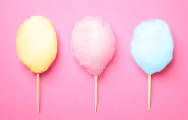  Sticks with different colorful yummy cotton candy on pink background, flat lay © New Africa