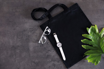 Flat lay composition with eco tote bag and accessories on grey background. Space for design