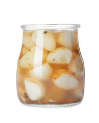 Glass jar with preserved garlic on white background