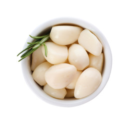 Bowl with preserved garlic and rosemary on white background, top view