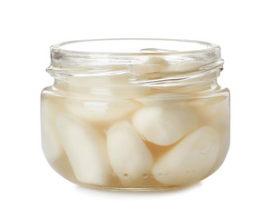 Glass jar with preserved garlic on white background