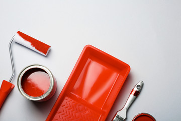 Flat lay composition with paint can, decorator tools and space for text on color background