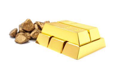 Gold nuggets and ingots on white background