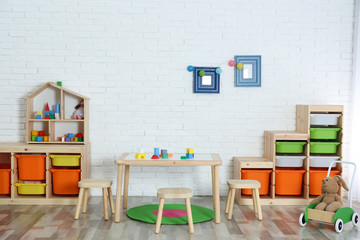Modern child room interior with table and stools