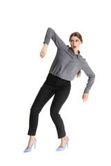 Young woman attracted to magnet on white background