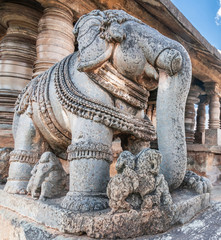 Belavadi, Karnataka, India - November 2, 2013: Veera Narayana Temple. Closeup of gray stone slarge statue of elephant on steps to sanctuary. 