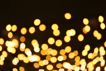 Beautiful golden lights on dark background. Bokeh effect