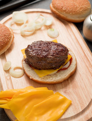 Preparing of hamburger with beef meat and baked bacon