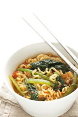 Korean spicy instant ramen with green leaf vegetable