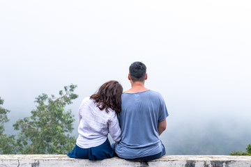 Young honeymoon couple posing on the edge, Bali island, Indonesia.