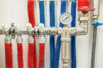 Plastic pipes of central heating system and water pipes in apartment