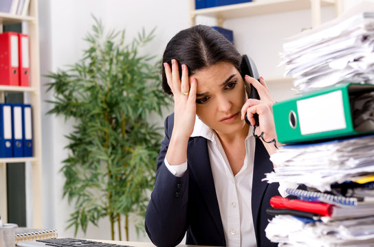 Female employee with too much work in the office 
