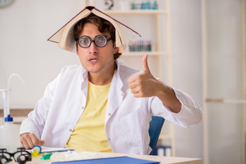 Funny crazy chemist doing experiments and tests