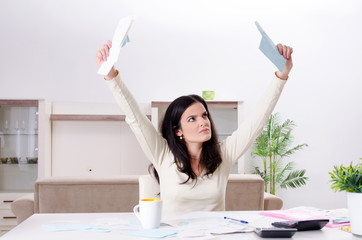 Young woman with receipts in budget planning concept 