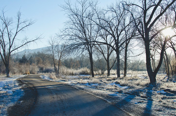 The long running trail cutting through the cold frosty parkway int the cold utah winter. 