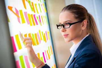 Beautiful female employee with many conflicting priorities 