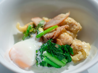 Asian dumplings in bow with Soft-boiled egg close-up