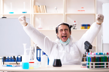 Young handsome chemist working in the lab 